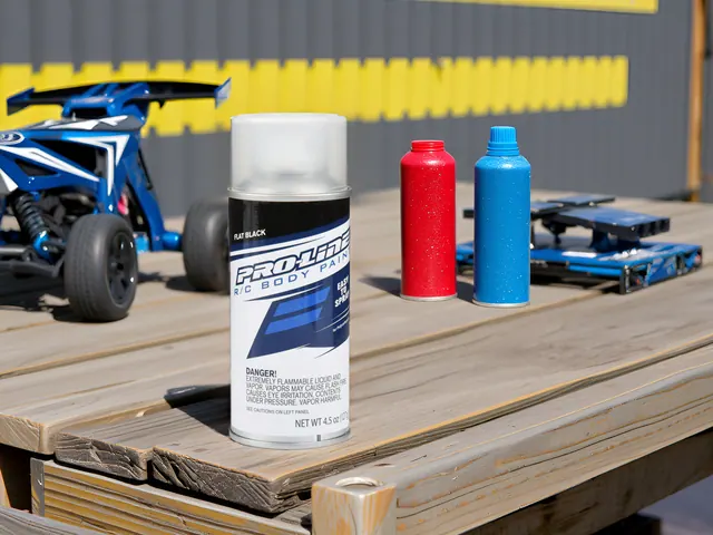 Pro-Line body paint cans on a pit table beside an RC buggy